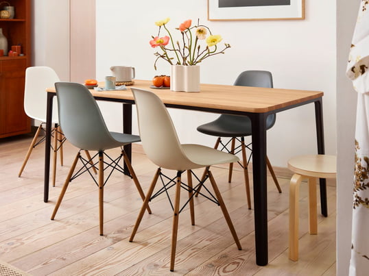 Der Eames Plastic Side Chair DSW von Vitra in der Ambienteansicht: Der DSW Stuhl wird durch seine besondere Kombination aus Holz und Kunststoff zum Highlight im Esszimmer.