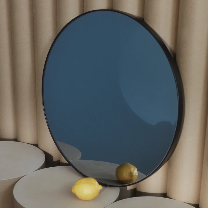 Der Circum Wandspiegel von AYTM angelehnt an einer wellblech-artigen Wand